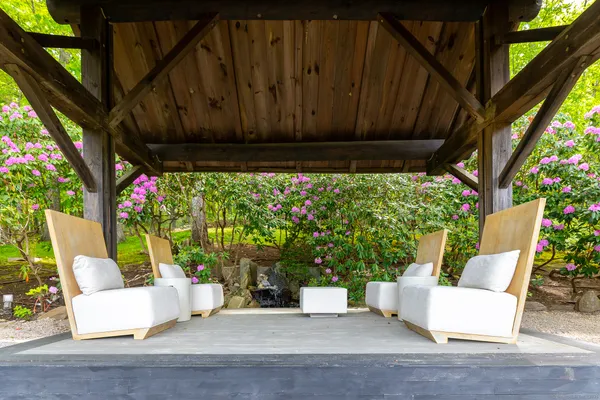 a view of backyard with table and chair and potted plants
