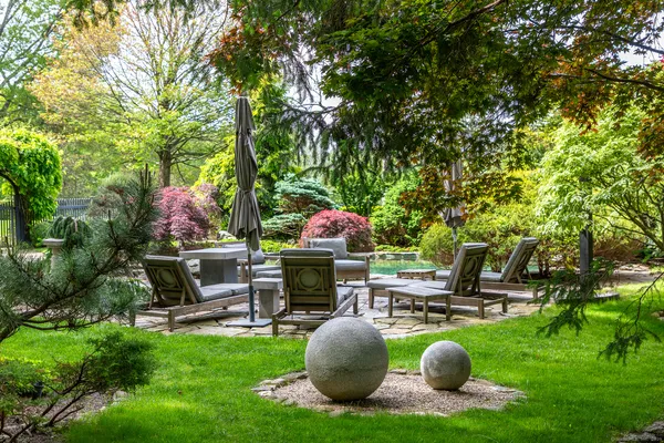 a backyard of a house with table and chairs