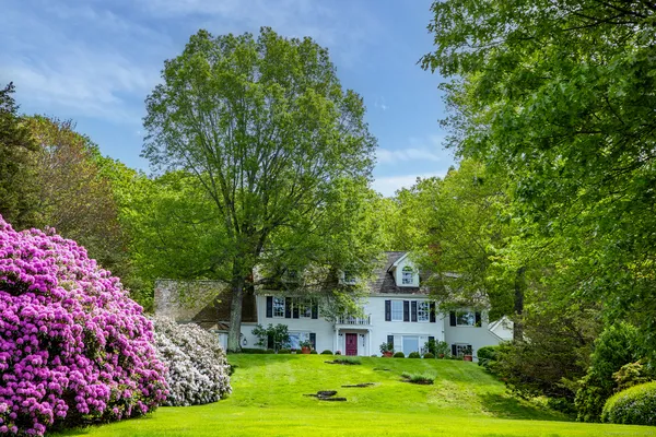 a front view of a house with garden