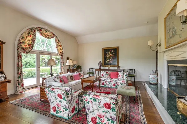 a living room with furniture and a floor to ceiling window