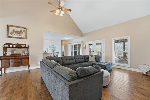 a living room with furniture and a wooden floor