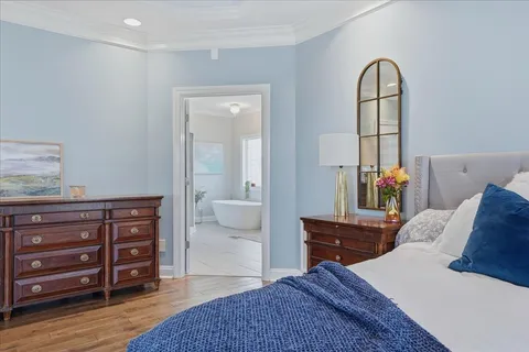 a spacious bathroom with a double vanity sink mirror and bathtub
