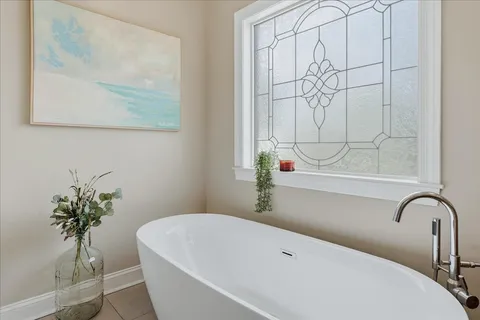 a bedroom with bed and a window