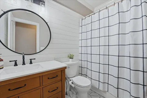 a bedroom with a bed and ceiling fan