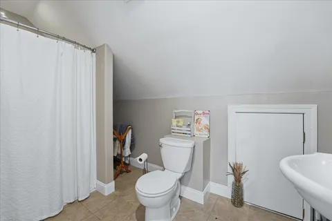 a living room with furniture and a ceiling fan