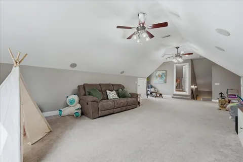 a view of swimming pool with chairs and brick wall