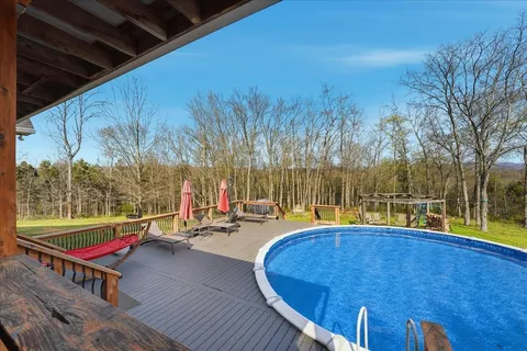 a view of a house with backyard and sitting area