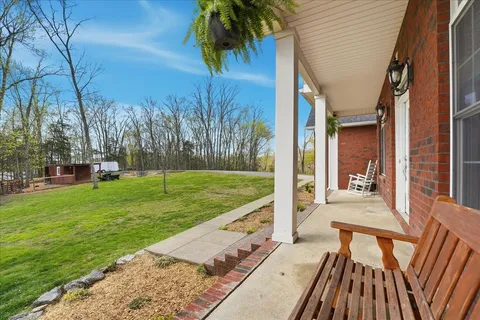 a backyard of a house with a yard and outdoor seating