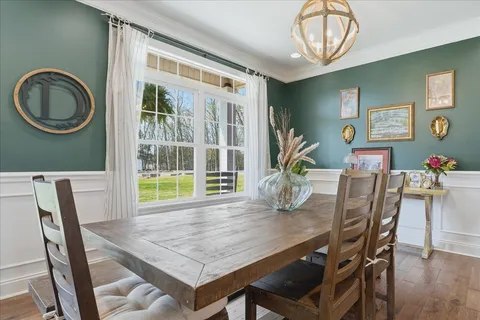 a dining room with furniture and window