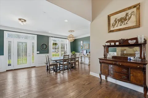 a view of a workspace with furniture and wooden floor