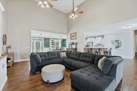 a living room with furniture and a wooden floor