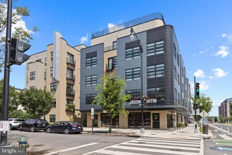 a view of a building and a cars park