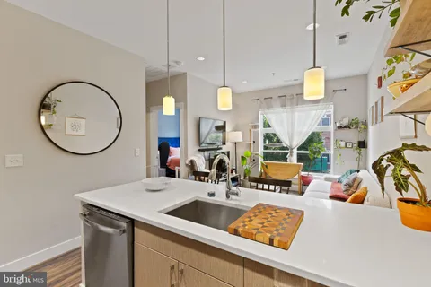 a view of a kitchen with a sink and a mirror