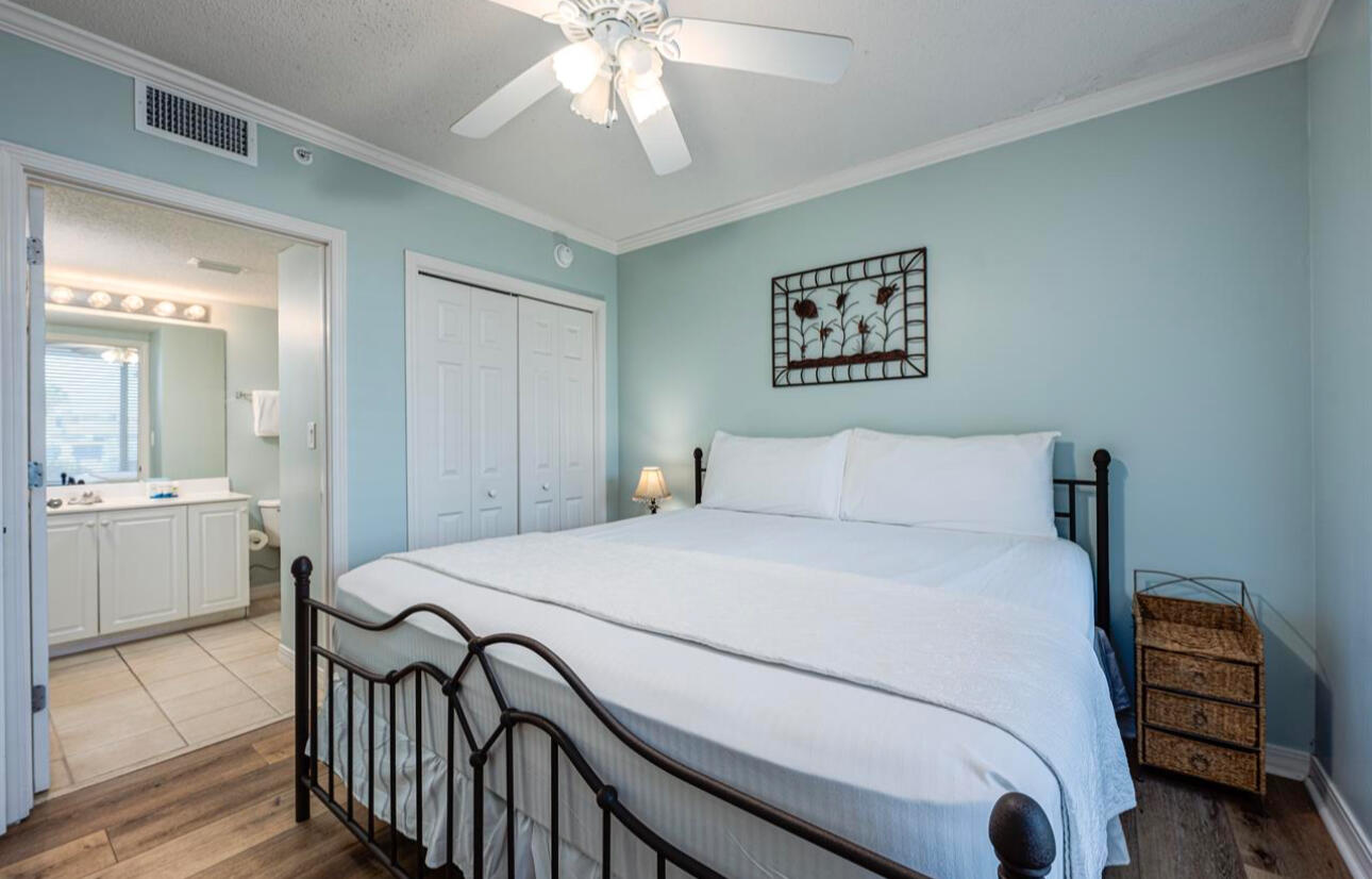 520 Santa Rosa Boulevard, Unit 100 Fort Walton Beach, FL 32548 - Photo 12 of 28 a bedroom with a bed and a chandelier