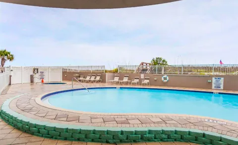 a view of a balcony with iron fence