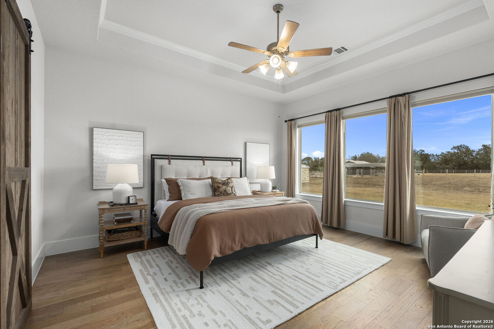 71 Sabinas Creek Ranch Road Boerne, TX 78006 - Photo 16 of 38 a bedroom with a large bed and a large window