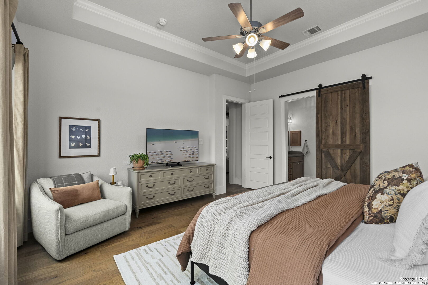 71 Sabinas Creek Ranch Road Boerne, TX 78006 - Photo 17 of 38 a bedroom with a bed couches and ceiling fan