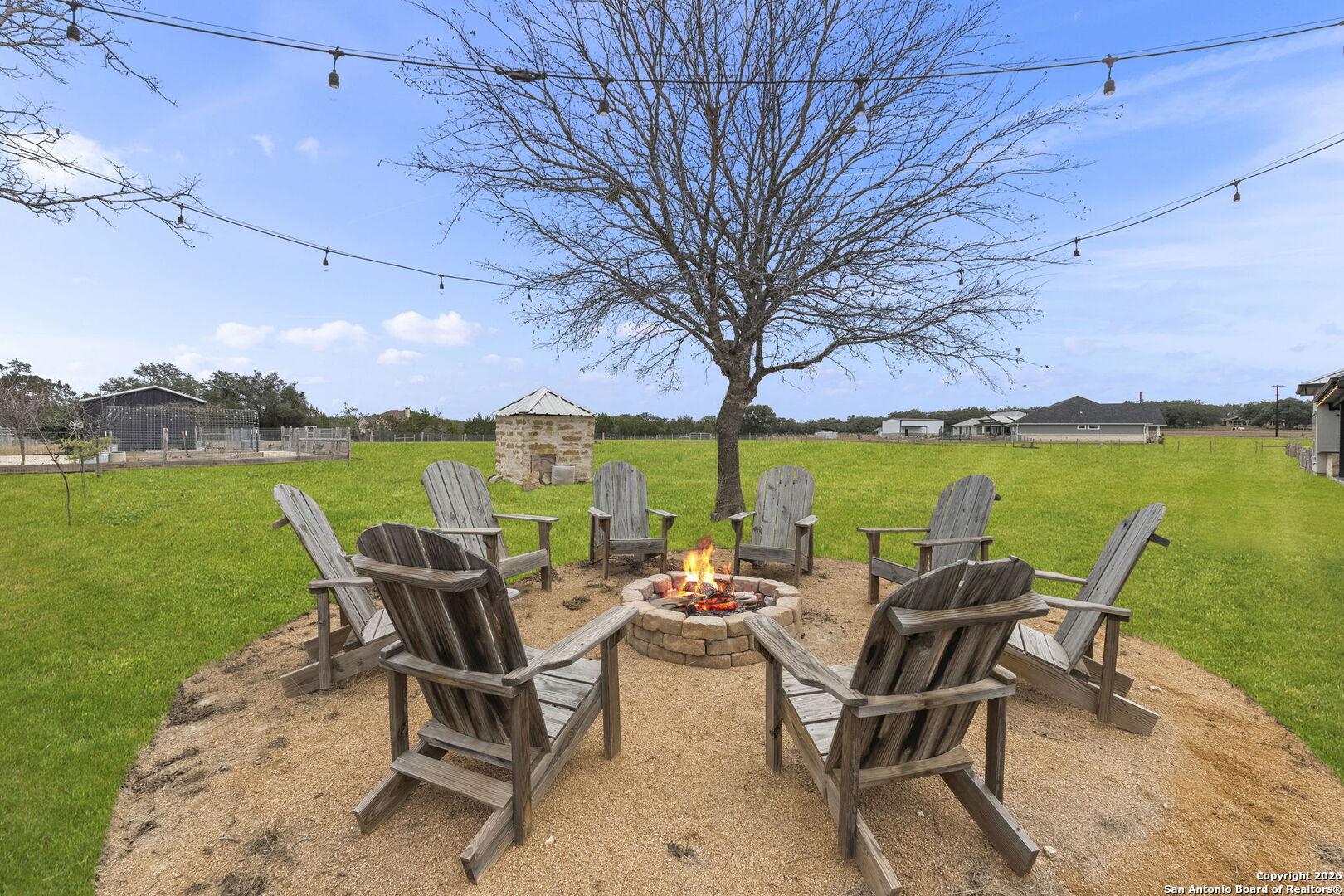 71 Sabinas Creek Ranch Road Boerne, TX 78006 - Photo 32 of 38 a view of a patio with chairs and table under an umbrella