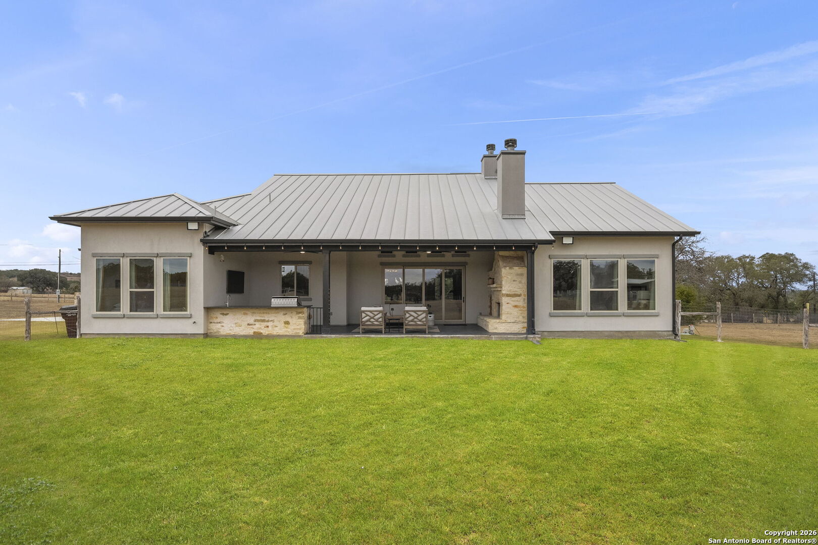 71 Sabinas Creek Ranch Road Boerne, TX 78006 - Photo 34 of 38 a front view of a house with swimming pool having outdoor seating