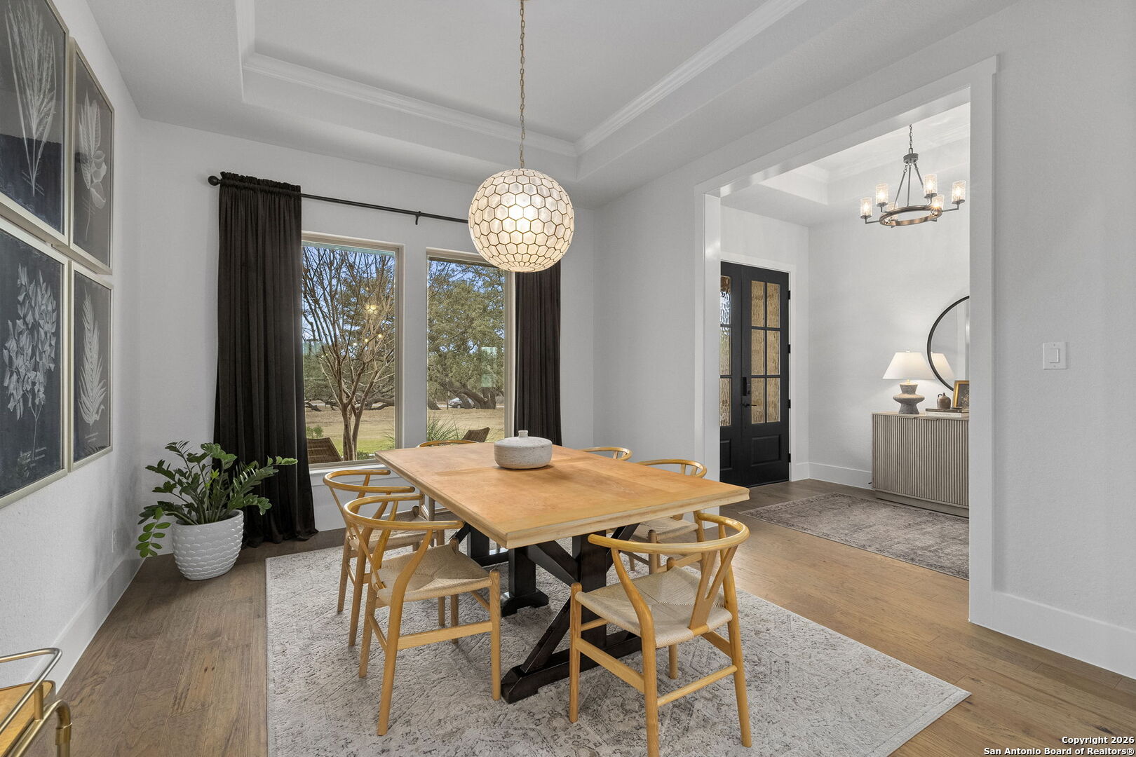 71 Sabinas Creek Ranch Road Boerne, TX 78006 - Photo 5 of 38 a view of a dining room with furniture window and wooden floor