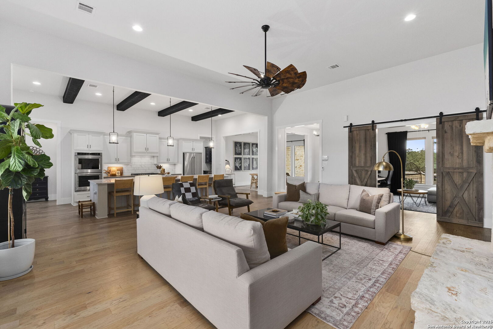 71 Sabinas Creek Ranch Road Boerne, TX 78006 - Photo 8 of 38 a living room with furniture kitchen view and a chandelier