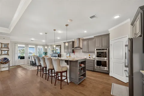 a large kitchen with a table and chairs