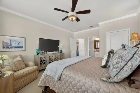 a bedroom with furniture and a flat screen tv