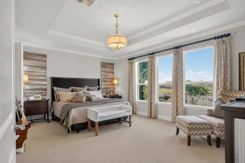 a bedroom with bed and a large window