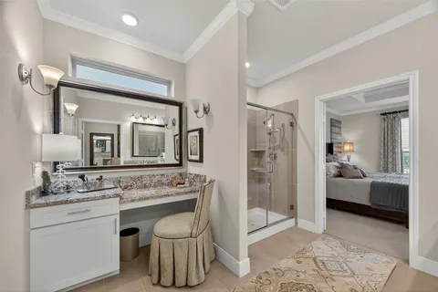 a en suite bathroom with a granite countertop sink and a mirror
