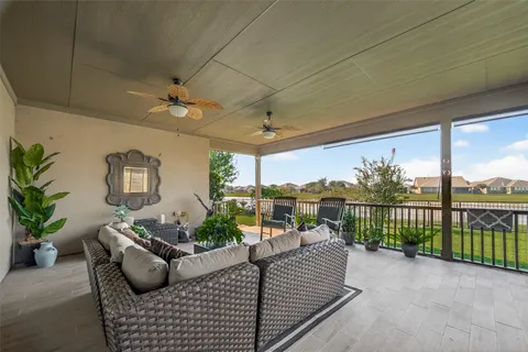 a balcony with furniture and a potted plant
