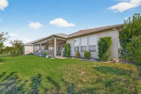 a view of a house with a yard and plants
