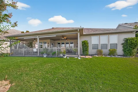 a view of a house with backyard porch and sitting area