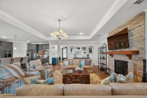 a living room with furniture a fireplace and a flat screen tv