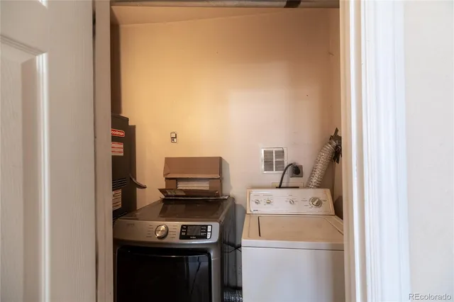 a view of storage and utility room with washer and dryer