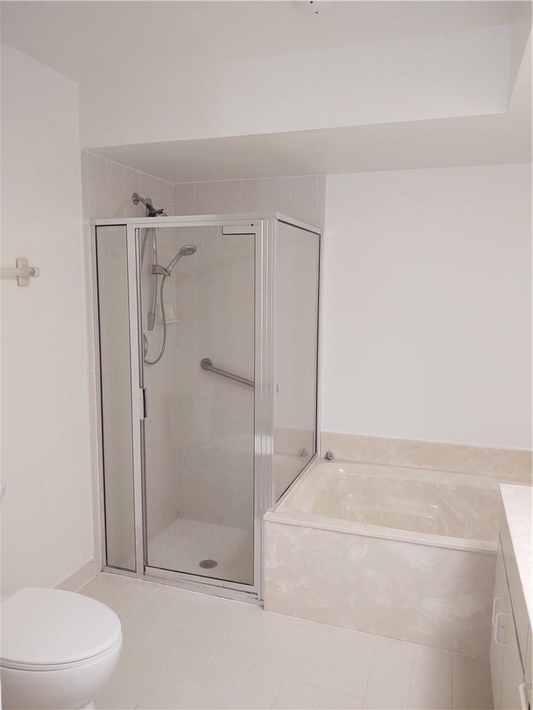 5801 Coach House Circle, Unit B Boca Raton, FL 33486 - Photo 18 of 39 Shower in master bath with soaking tub