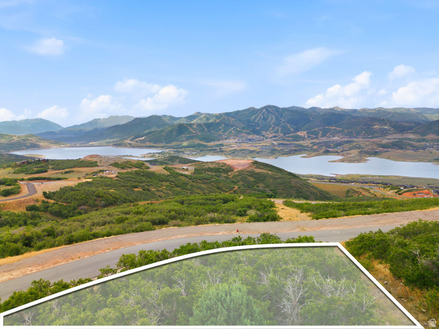 1845 East Outlaw Road, Unit 352 Hideout, UT 84036 - Photo 3 of 12 Mountain landscape with a substantial body of water, distant hills, and a paved road