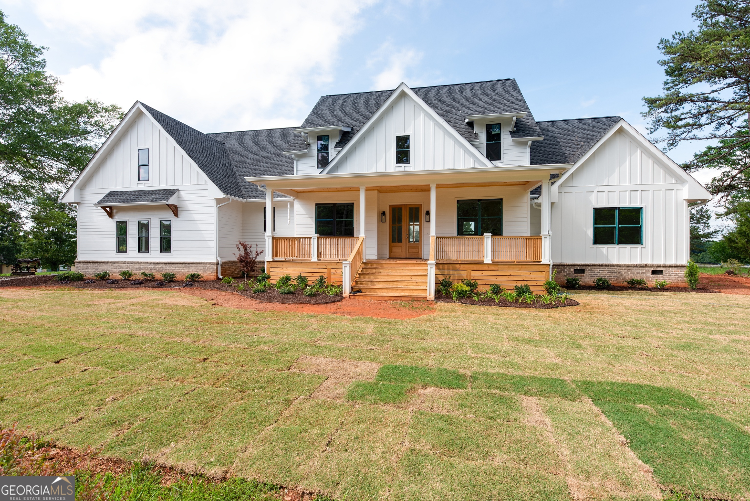 a front view of a house with yard patio and fire pit