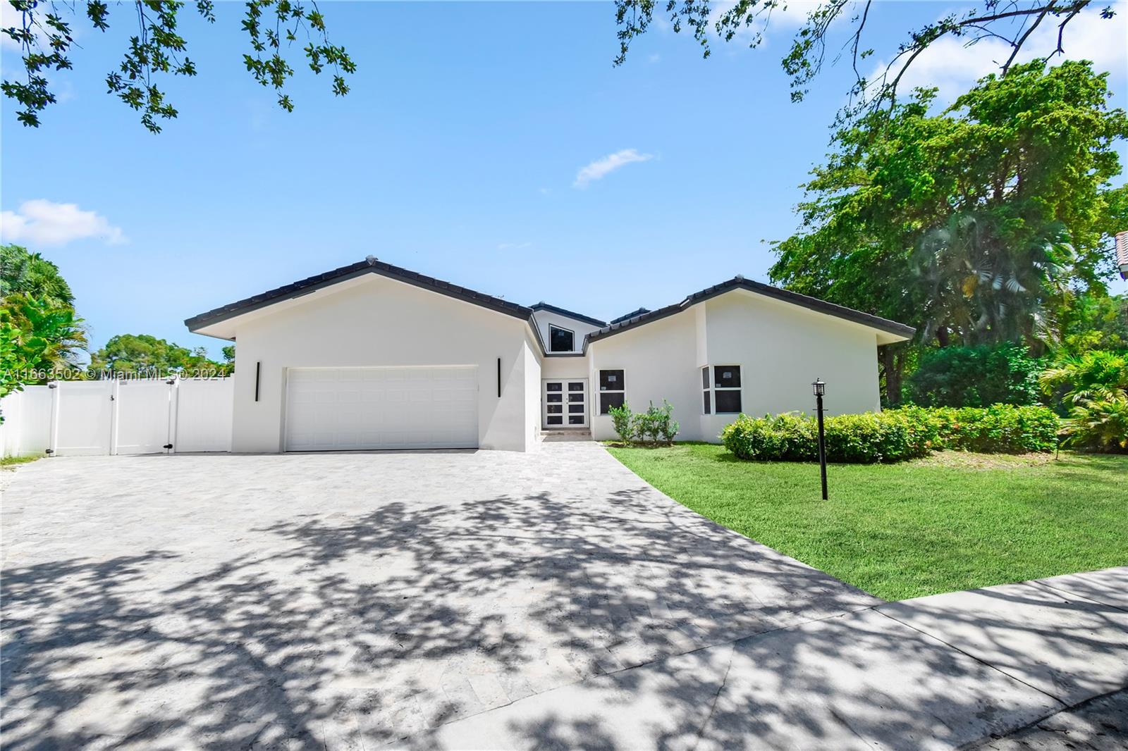 4299 Northwest 26th Court Boca Raton, FL 33434 - Photo 8 of 47 a house with a yard and a large parking space