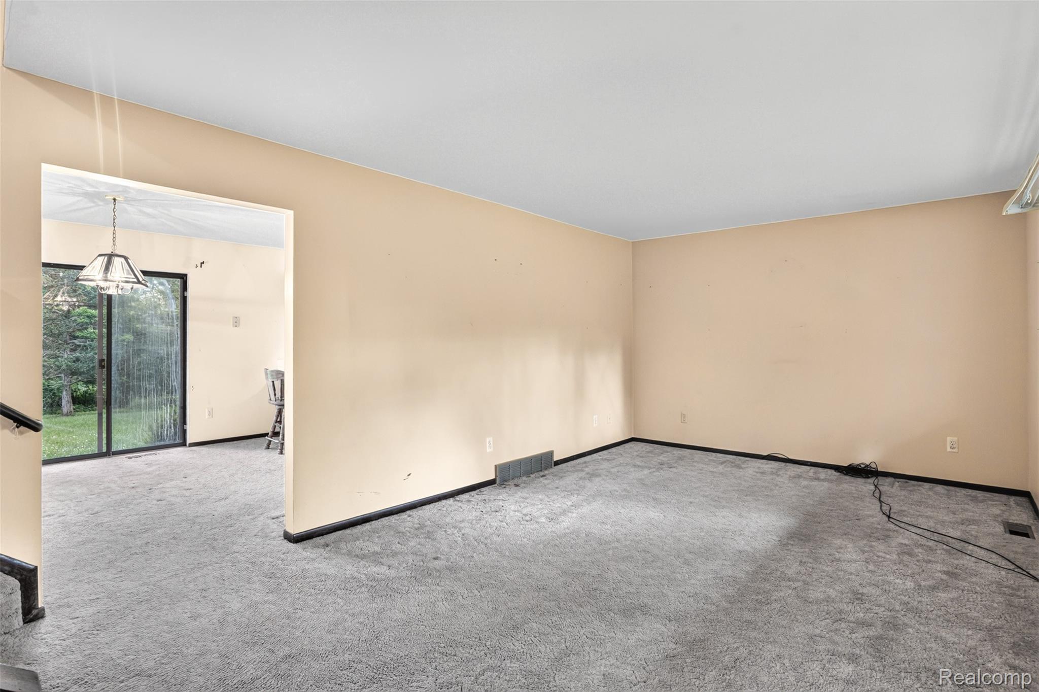 16955 English Road Manchester, MI 48158 - Photo 5 of 37 Spacious interior room with light beige walls and grey carpeting