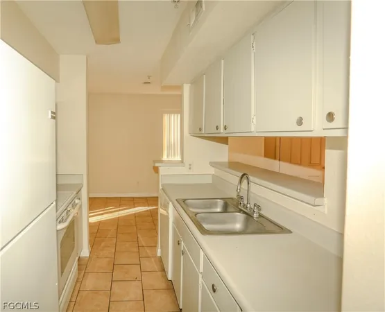 a kitchen with a sink and a refrigerator