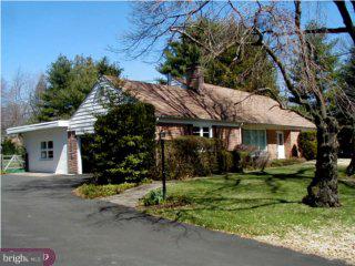 1421 Holcomb Road Huntingdon Valley, PA 19006 - Photo 1 of 5 a front view of a house with a garden