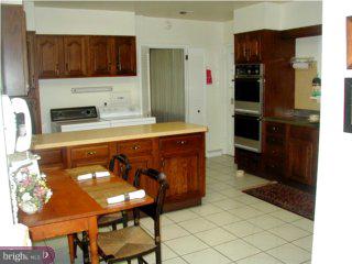 1421 Holcomb Road Huntingdon Valley, PA 19006 - Photo 3 of 5 a kitchen with a sink refrigerator and cabinets