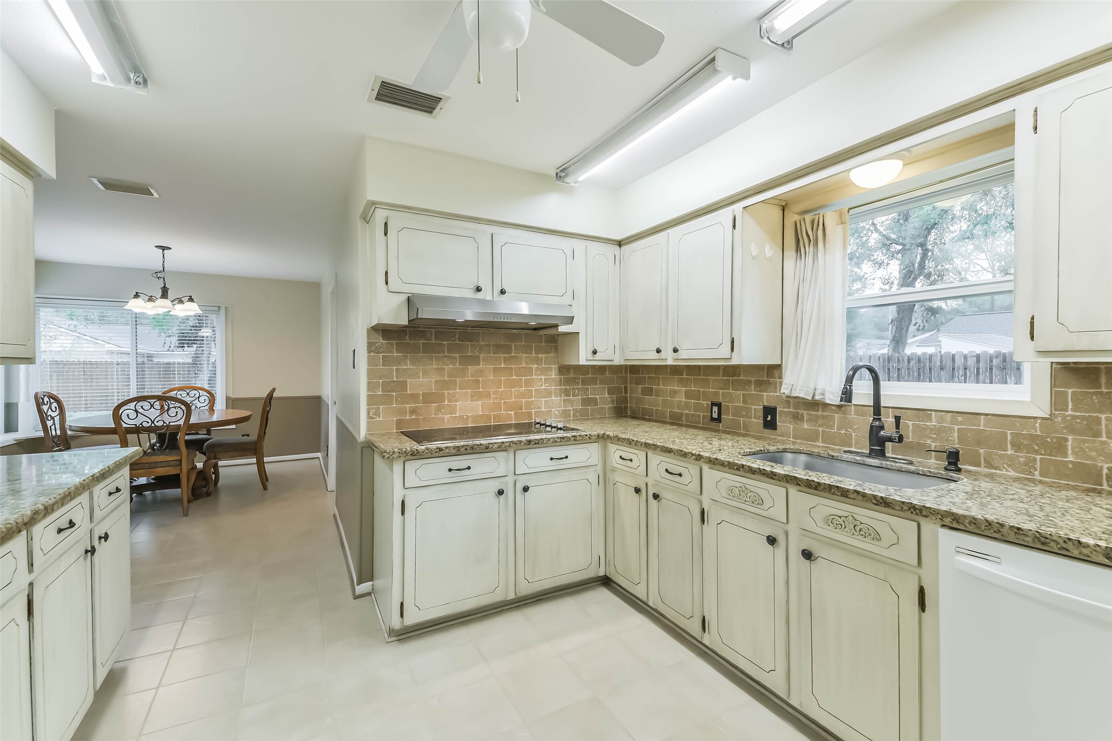 1210 Timber Lane Rosenberg, TX 77471 - Photo 11 of 48 a kitchen with granite countertop cabinets a sink dishwasher and white appliances with wooden floor