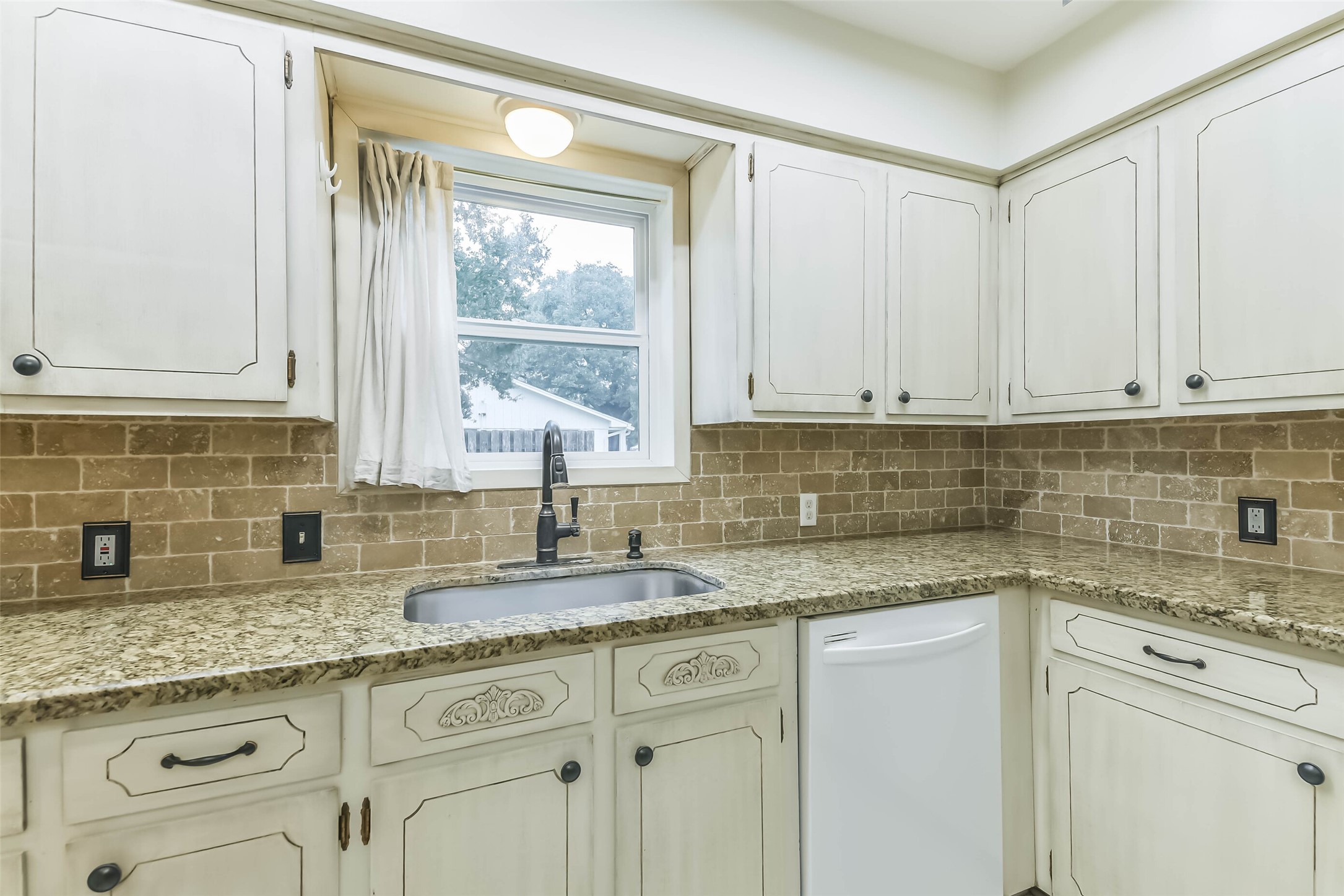1210 Timber Lane Rosenberg, TX 77471 - Photo 13 of 48 a kitchen with granite countertop white cabinets and a window