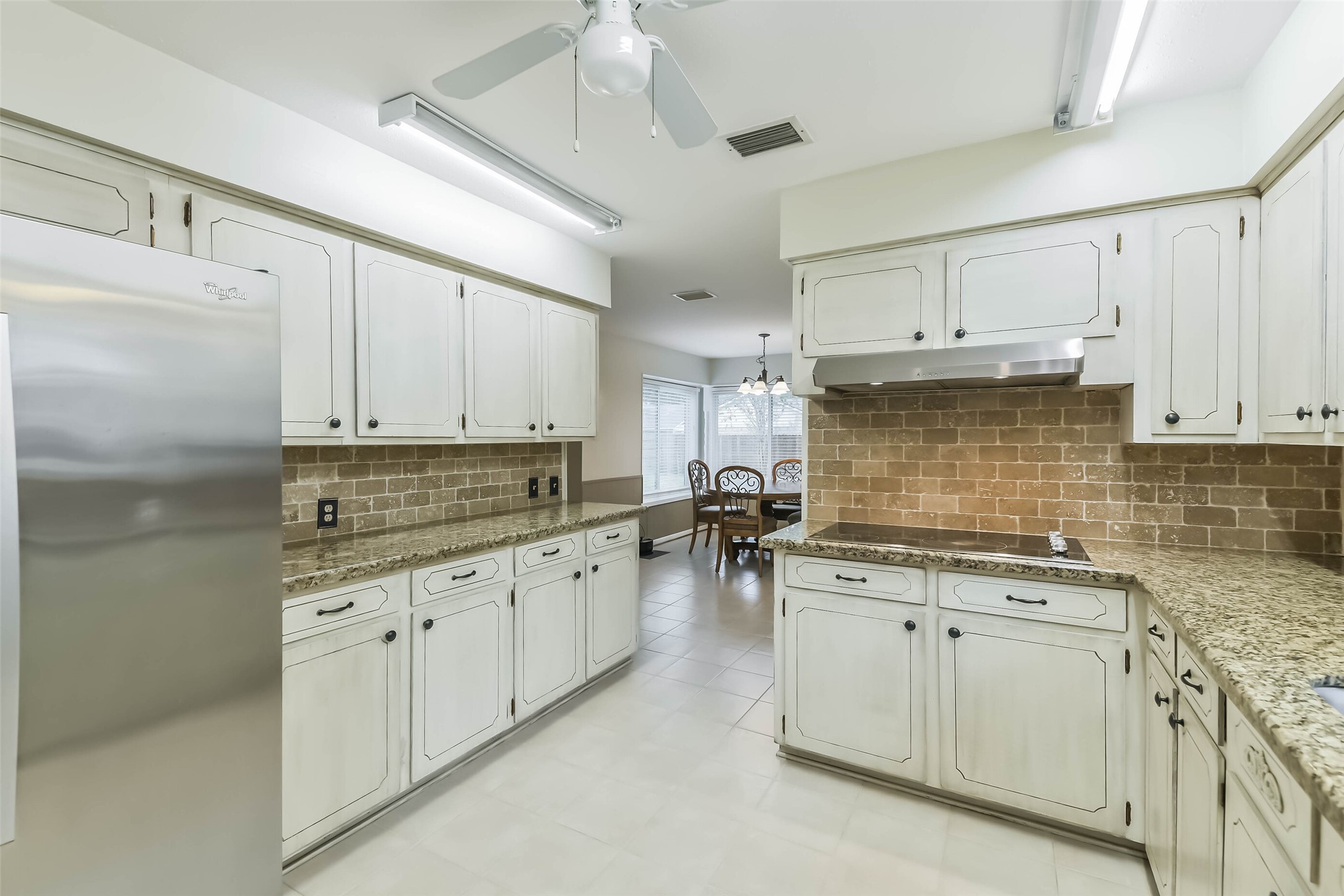 1210 Timber Lane Rosenberg, TX 77471 - Photo 14 of 48 a kitchen with granite countertop a sink cabinets stainless steel appliances and a window