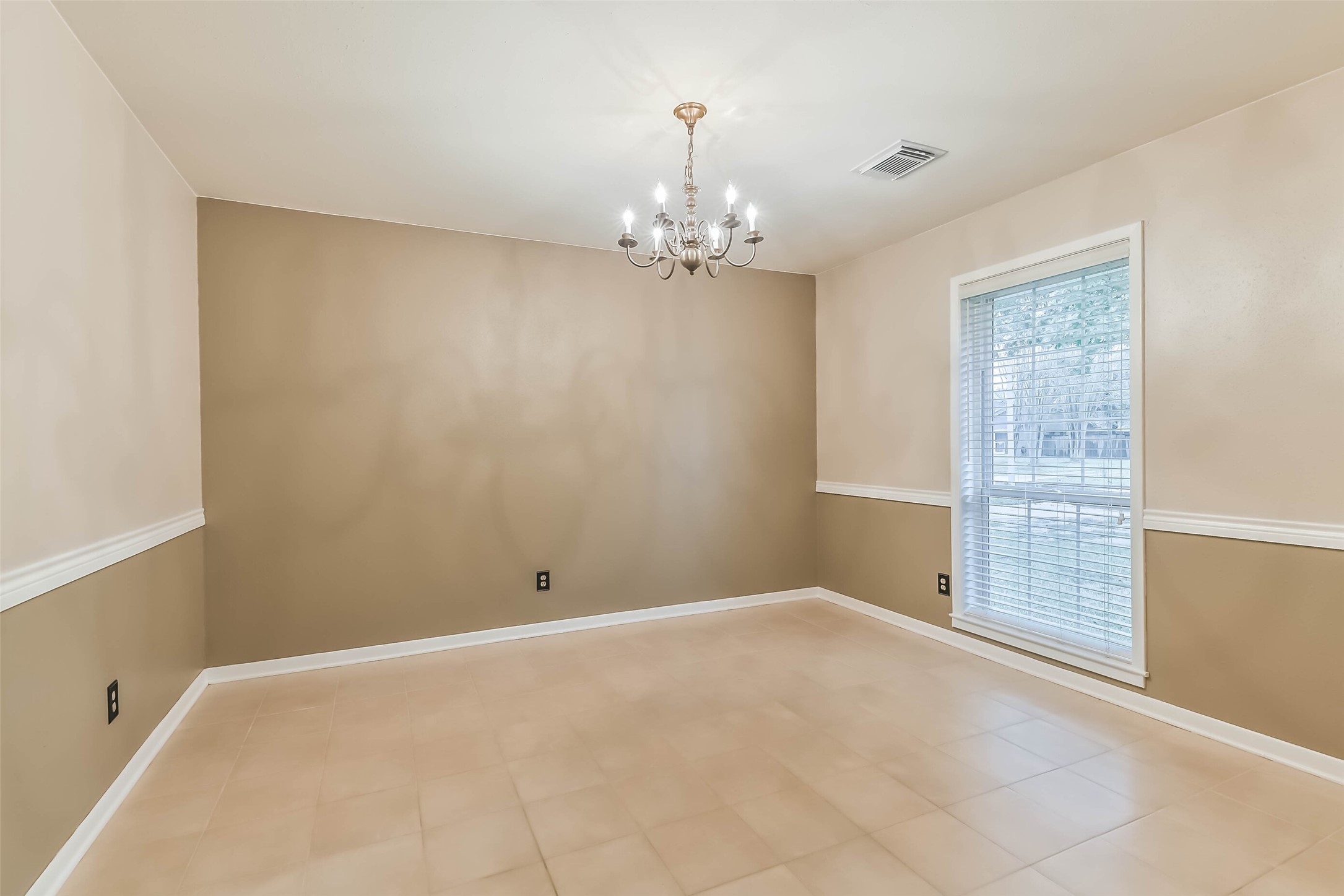 1210 Timber Lane Rosenberg, TX 77471 - Photo 15 of 48 a view of an empty room with chandelier