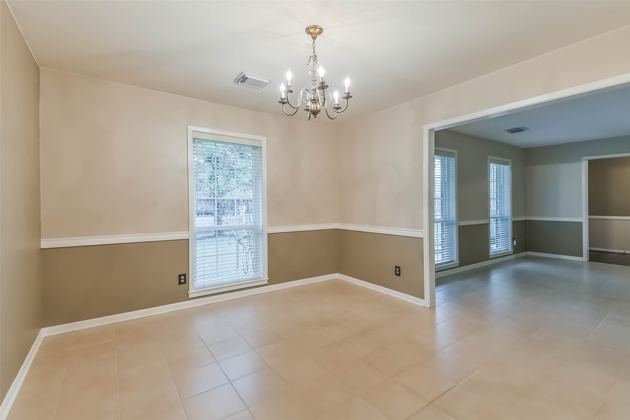 1210 Timber Lane Rosenberg, TX 77471 - Photo 16 of 48 a view of an empty room with chandelier and a window