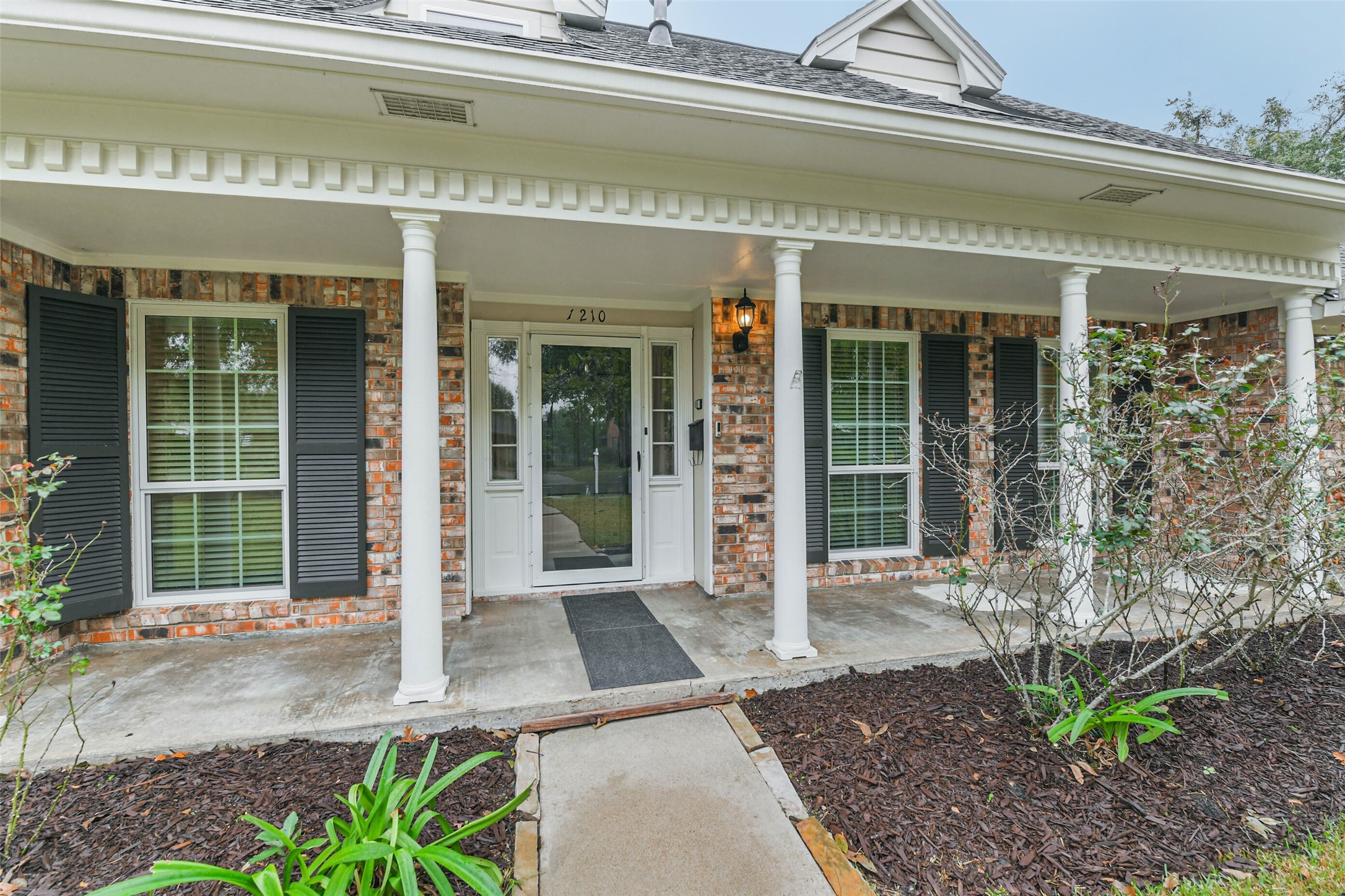 1210 Timber Lane Rosenberg, TX 77471 - Photo 2 of 48 a front view of a building with garden