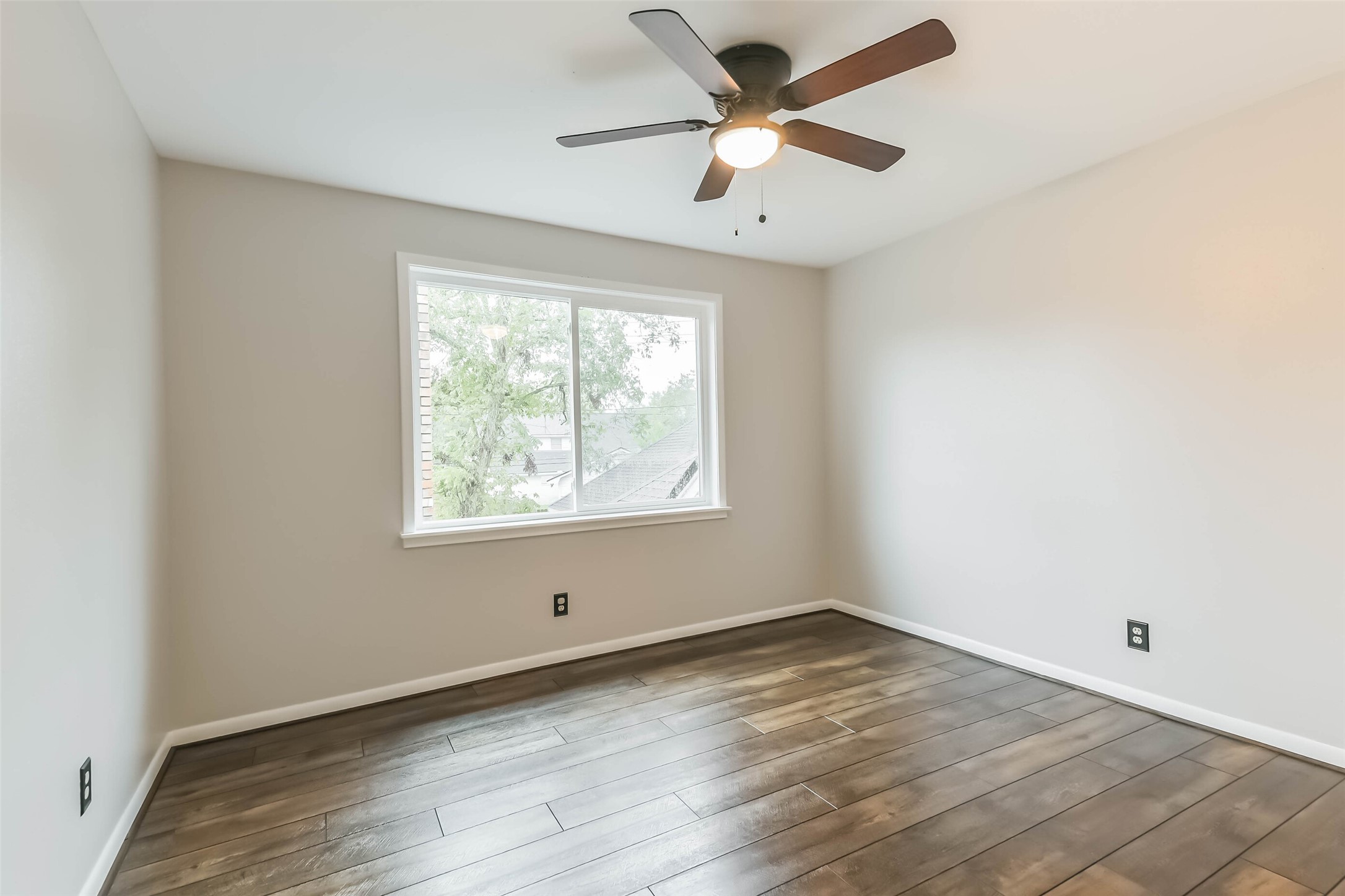 1210 Timber Lane Rosenberg, TX 77471 - Photo 33 of 48 an empty room with wooden floor and windows