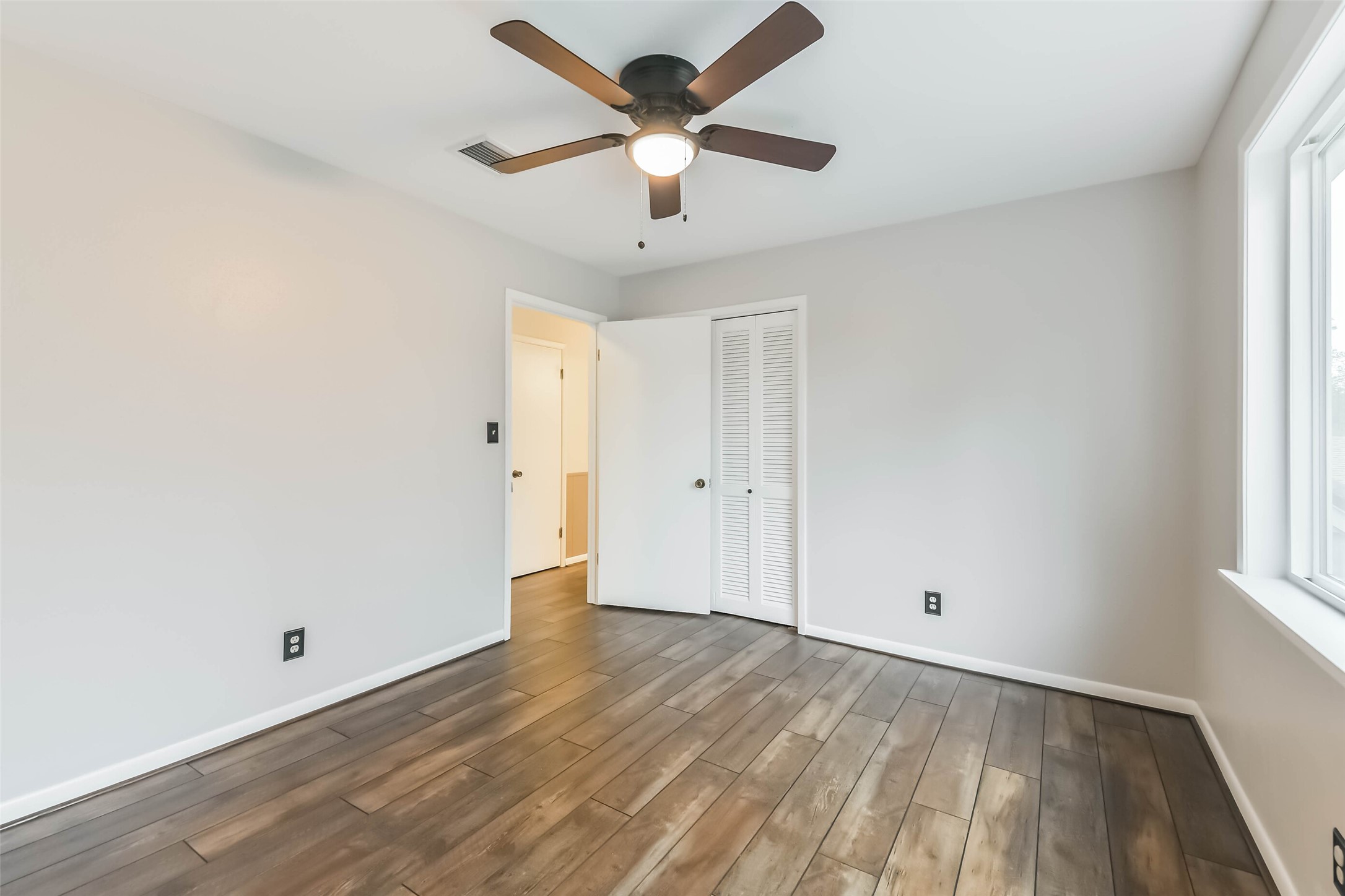 1210 Timber Lane Rosenberg, TX 77471 - Photo 34 of 48 wooden floor in an empty room with a window
